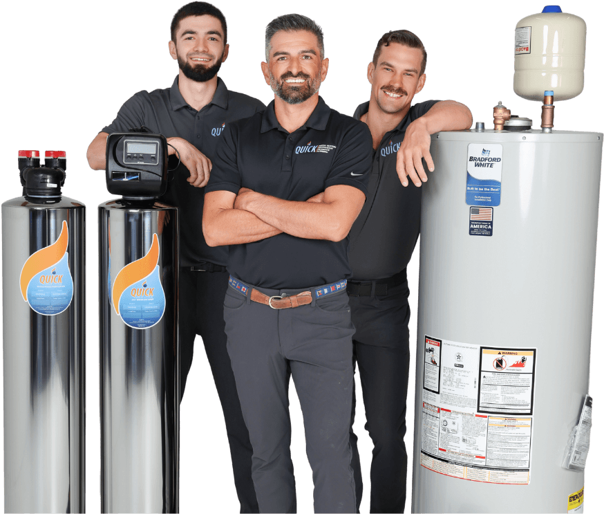 Three of the Quick Water Heater crew in company polos, standing between two Quick filtration systems and a Bradford White water heater